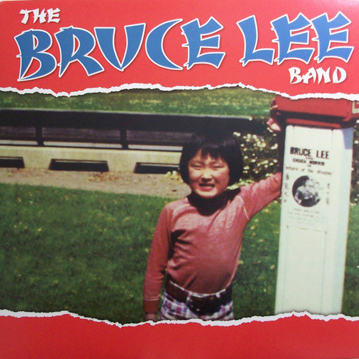 The Album art for The Bruce Lee Band by The Bruce Lee Band. A little Asian boy is standing next to a flyer featuring Bruce Lee he is happy.