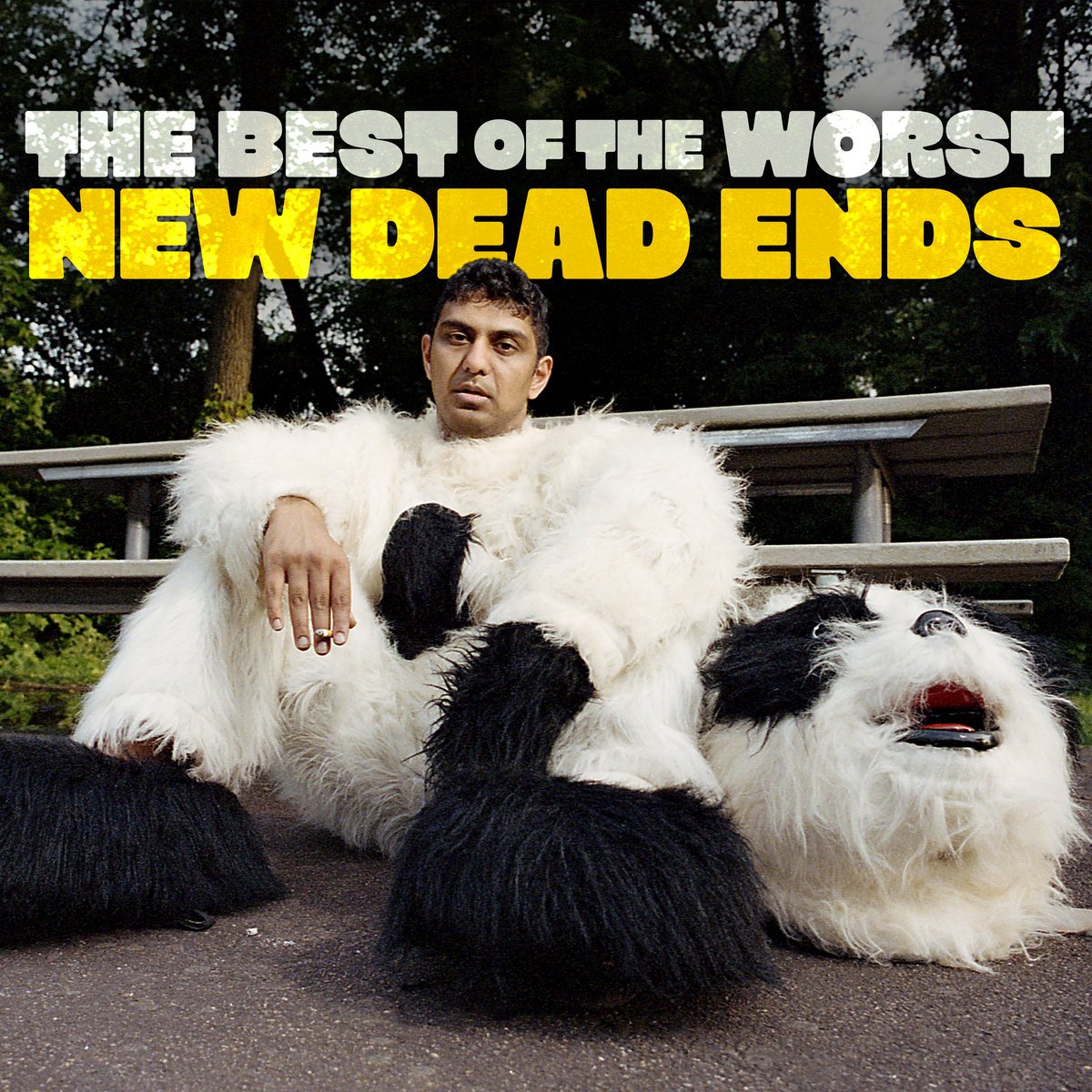 This is the album art for New Dead Ends by The Best of the Worst. The Band name “The Best of the worst” is in white at the top of the image below it is “New Dead Ends” in yellow. The main image is of an exhausted man wearing a mascot costume sitting on the ground. The head of the costume rests on the ground beside him.
